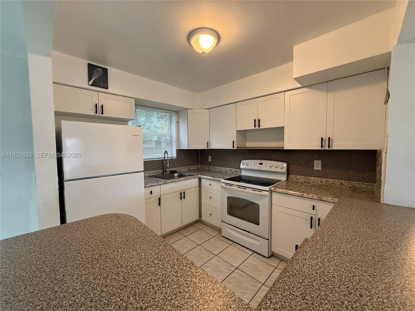 301 North 70th Avenue Hollywood, FL 33024 - Photo 5 of 14 a kitchen with cabinets stainless steel appliances and a counter space