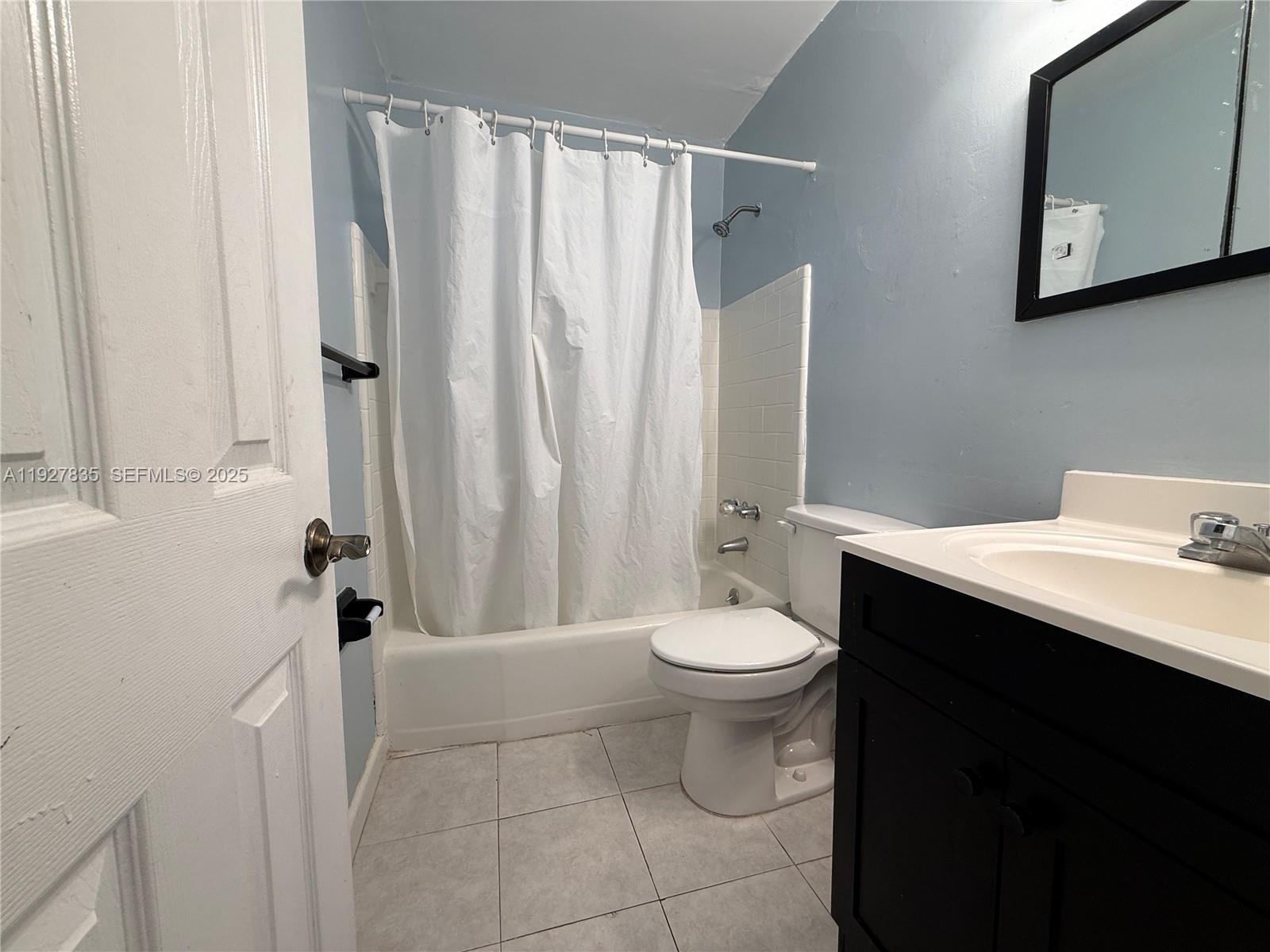 301 North 70th Avenue Hollywood, FL 33024 - Photo 8 of 14 a bathroom with a sink a toilet and shower curtain