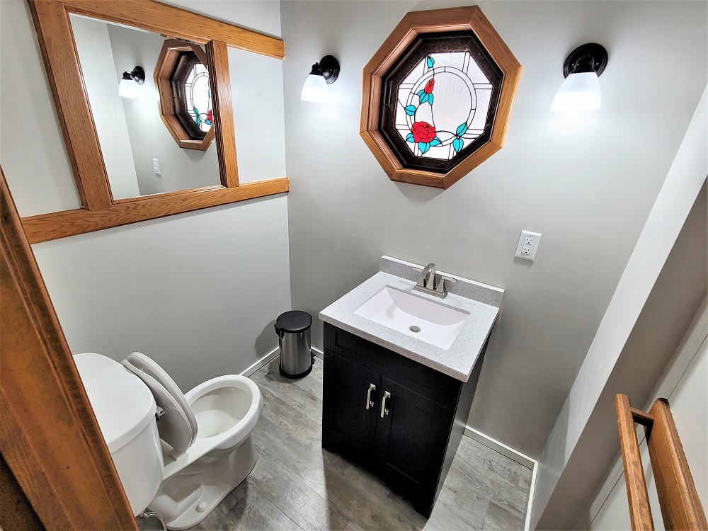 1002 Chestnut Avenue Dixon, IL 61021 - Photo 12 of 30 a bathroom with a toilet a sink and a mirror