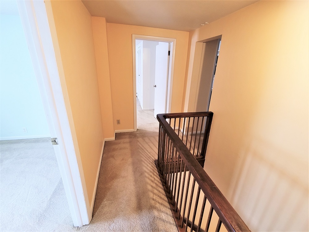 1002 Chestnut Avenue Dixon, IL 61021 - Photo 21 of 30 a view of a hallway with wooden floor and staircase