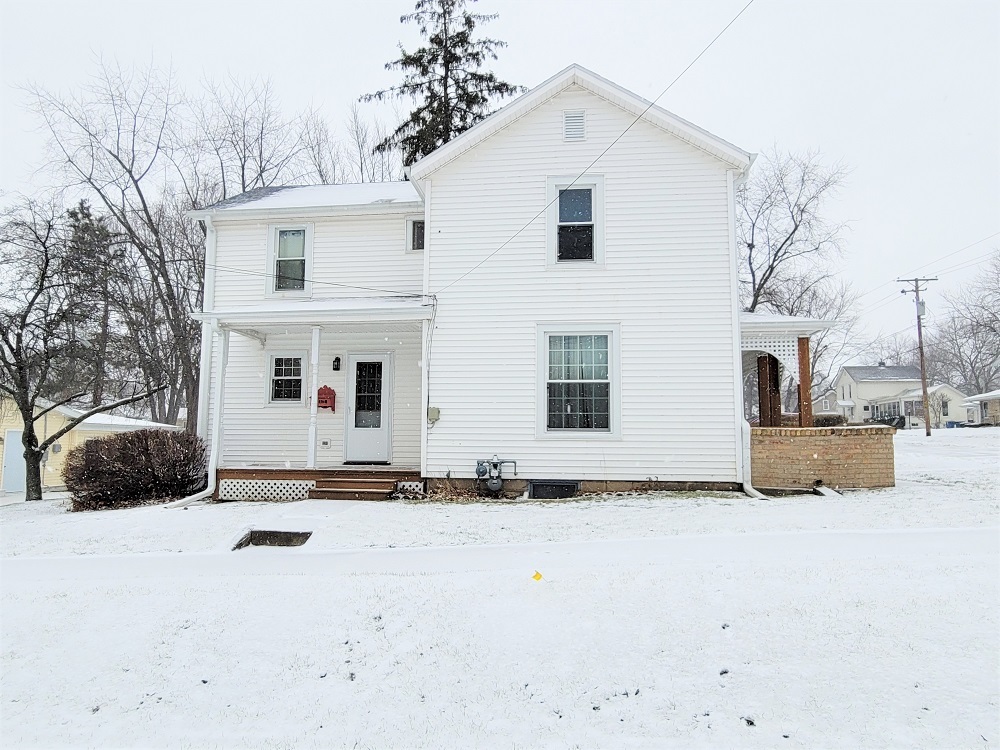 1002 Chestnut Avenue Dixon, IL 61021 - Photo 25 of 30 a view of a white house with a yard covered in snow