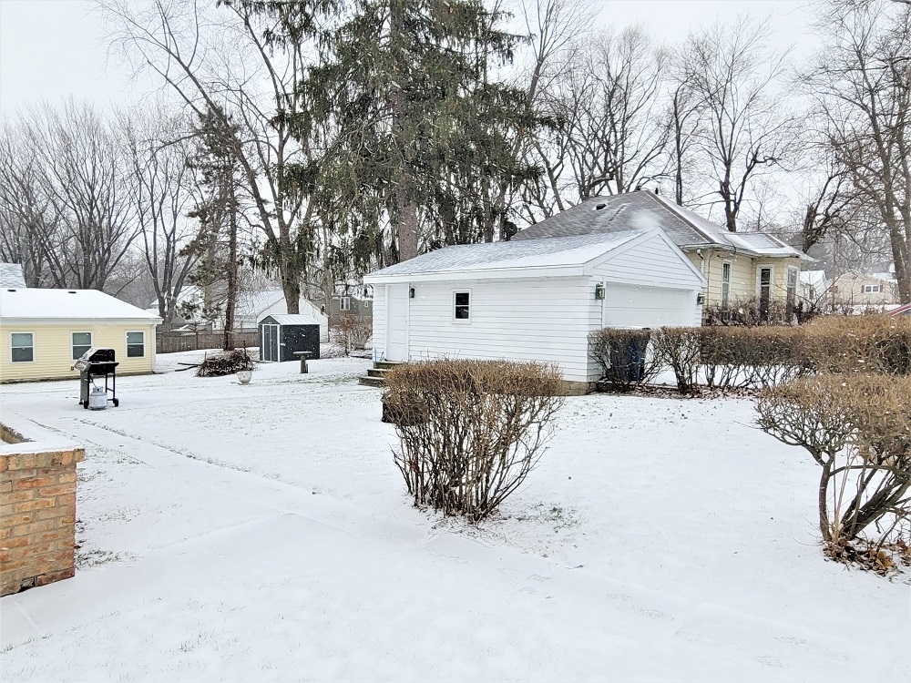 1002 Chestnut Avenue Dixon, IL 61021 - Photo 26 of 30 a view of a white house covered in snow