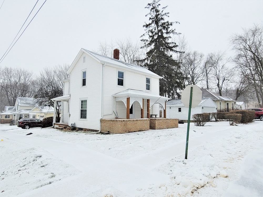 1002 Chestnut Avenue Dixon, IL 61021 - Photo 30 of 30 a view of a white house covered in snow