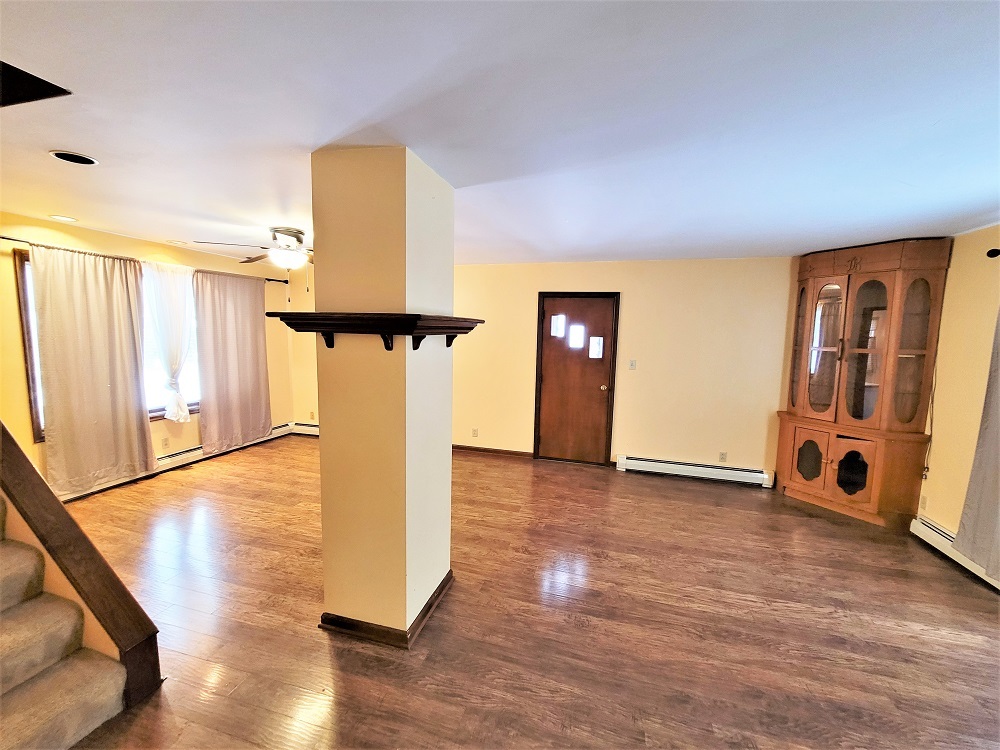 1002 Chestnut Avenue Dixon, IL 61021 - Photo 4 of 30 a view of a livingroom with wooden floor and a ceiling fan