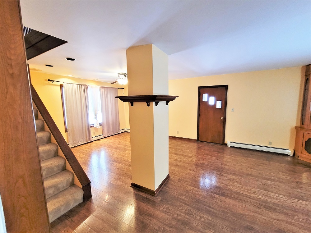 1002 Chestnut Avenue Dixon, IL 61021 - Photo 5 of 30 a view of a hallway with wooden floor and staircase