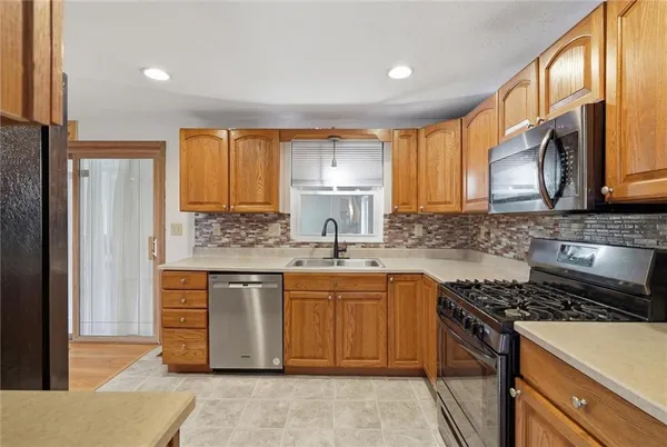 a kitchen with a refrigerator and a sink