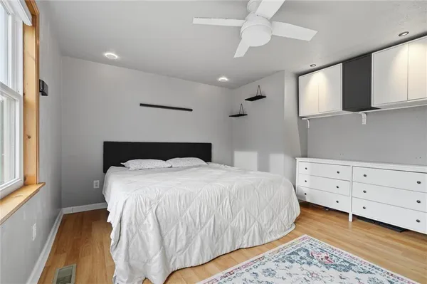 a bedroom with a large bed and a window