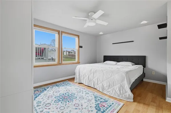a bedroom with a bed and a large window
