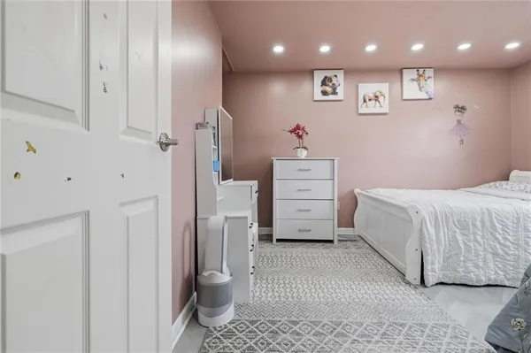 a bedroom with two beds and a dresser