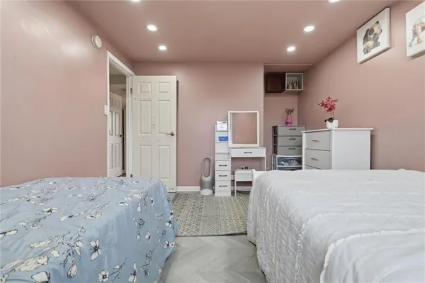 a bedroom with a bed and a computer on the desk