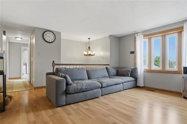 a living room with furniture cabinets and a flat screen tv