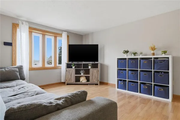 a living room with furniture and a book shelf