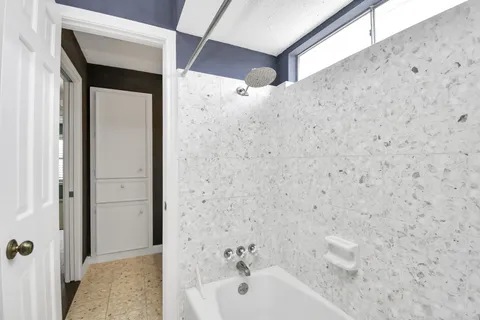 a bathroom with a bathtub and shower