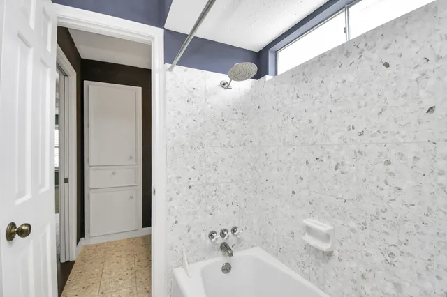 a bathroom with a bathtub and shower