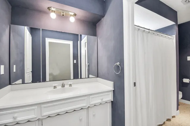 a bathroom with a double vanity sink and a mirror