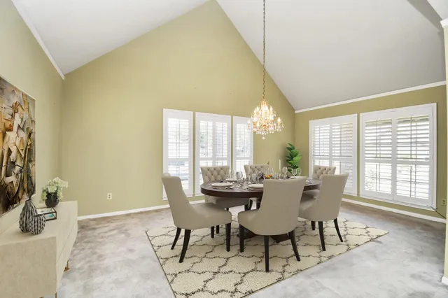 a dining room with furniture and window