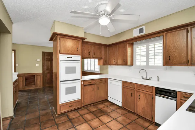 a kitchen with a sink appliances and cabinets