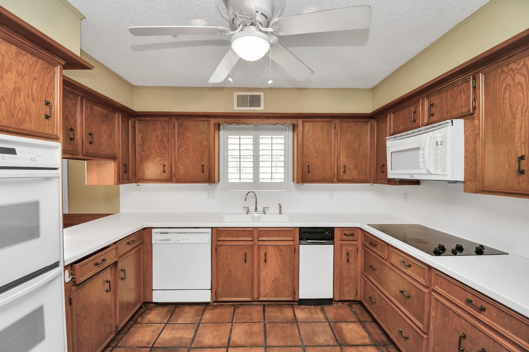 3114 Audubon Court Sugar Land, TX 77478 - Photo 10 of 29 a kitchen with a stove window and cabinets