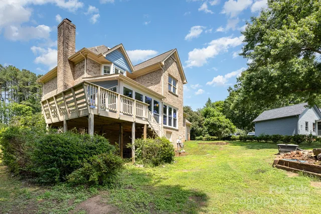 a view of a house with swimming pool and sitting area
