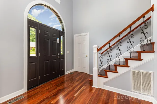 a view of entryway with wooden floor and stairs
