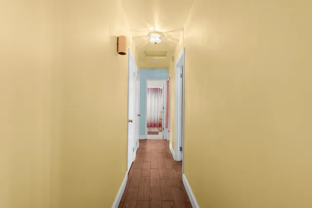 an empty room with a chandelier fan