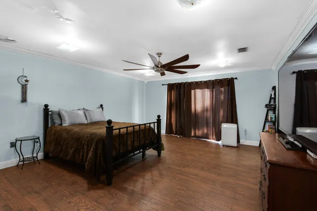 a spacious bathroom with a granite countertop sink a toilet and a mirror