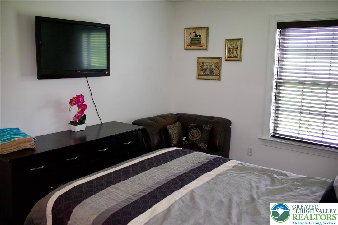 101 Cider Mill Road Mertztown, PA 19539 - Photo 10 of 26 a bedroom with a bed and a flat screen tv