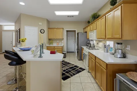 a kitchen with sink cabinets and stove
