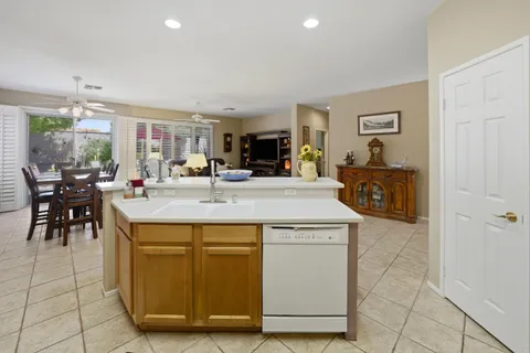 a kitchen with kitchen island a counter top space a sink and cabinets