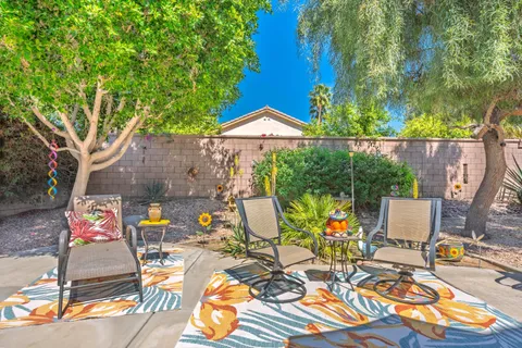 a view of a chairs and table in patio