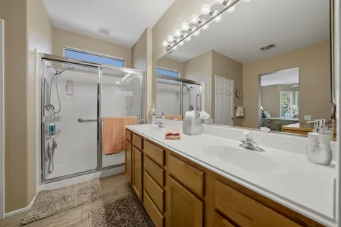 a bathroom with a sink double vanity and a mirror