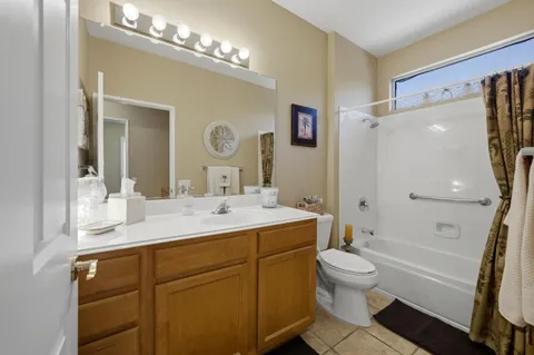 a bathroom with a sink a toilet and shower a mirror