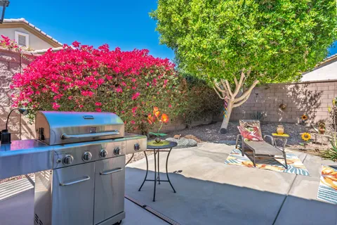 a view of a backyard with sitting area and furniture