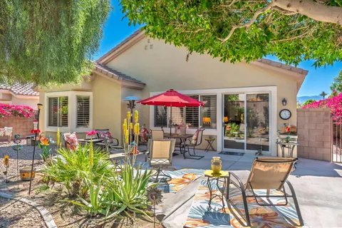 a view of a house with patio and sitting area