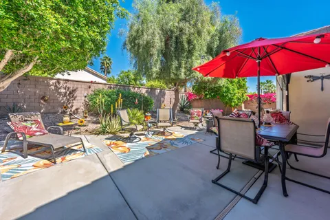an outdoor space with furniture and umbrella