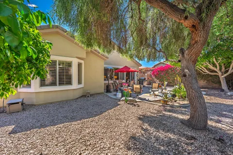a view of a patio with a table and chairs under an umbrella