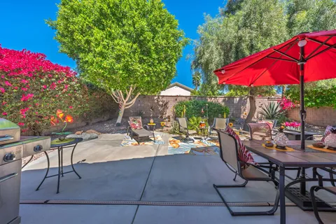 a view of a backyard with sitting area and furniture