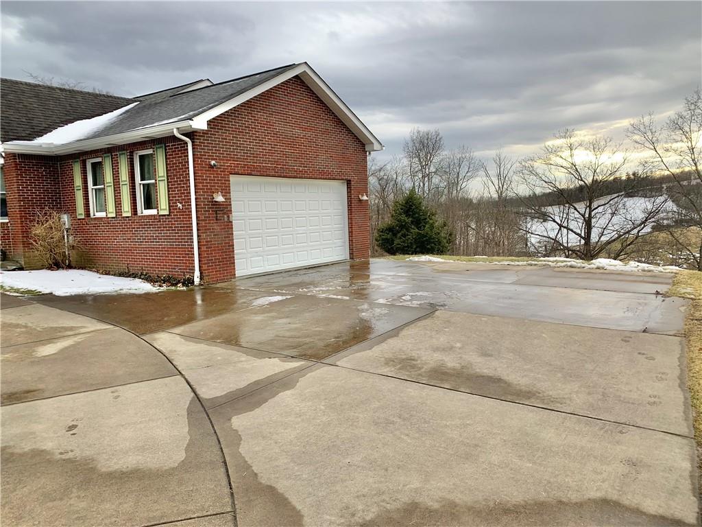1257 Amity Ridge Road Amity, PA 15311 - Photo 17 of 21 a front view of a house with a yard and garage
