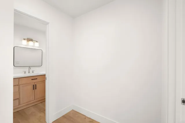 a bathroom with a toilet sink vanity and mirror