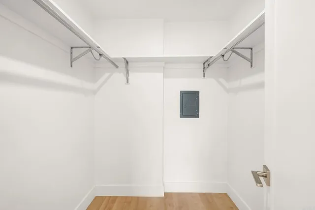 a view of walk in closet with empty racks