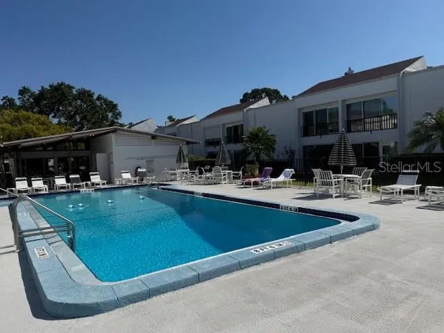 a view of a swimming pool with outdoor seating