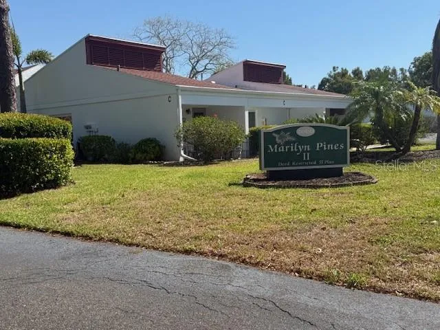 a sign that is sitting in front of a house