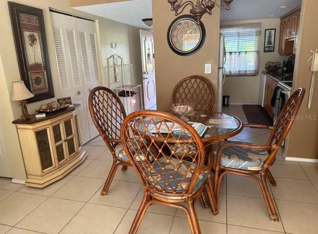a view of a dining room with furniture and a chandelier