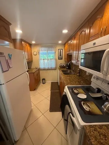 a kitchen with stainless steel appliances granite countertop a stove and a refrigerator