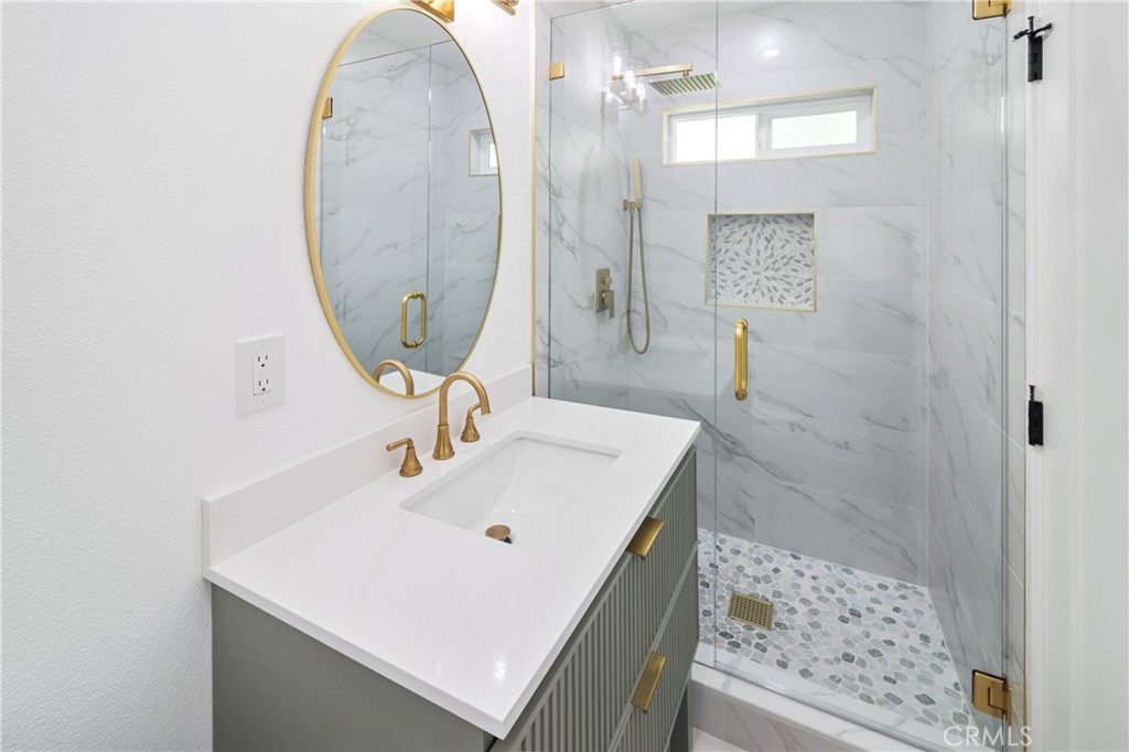 11452 Earlham Street Orange, CA 92869 - Photo 14 of 30 a bathroom with a sink a mirror and shower