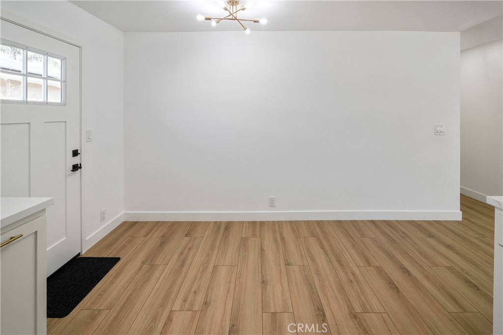 11452 Earlham Street Orange, CA 92869 - Photo 4 of 30 an empty room with wooden floor and windows