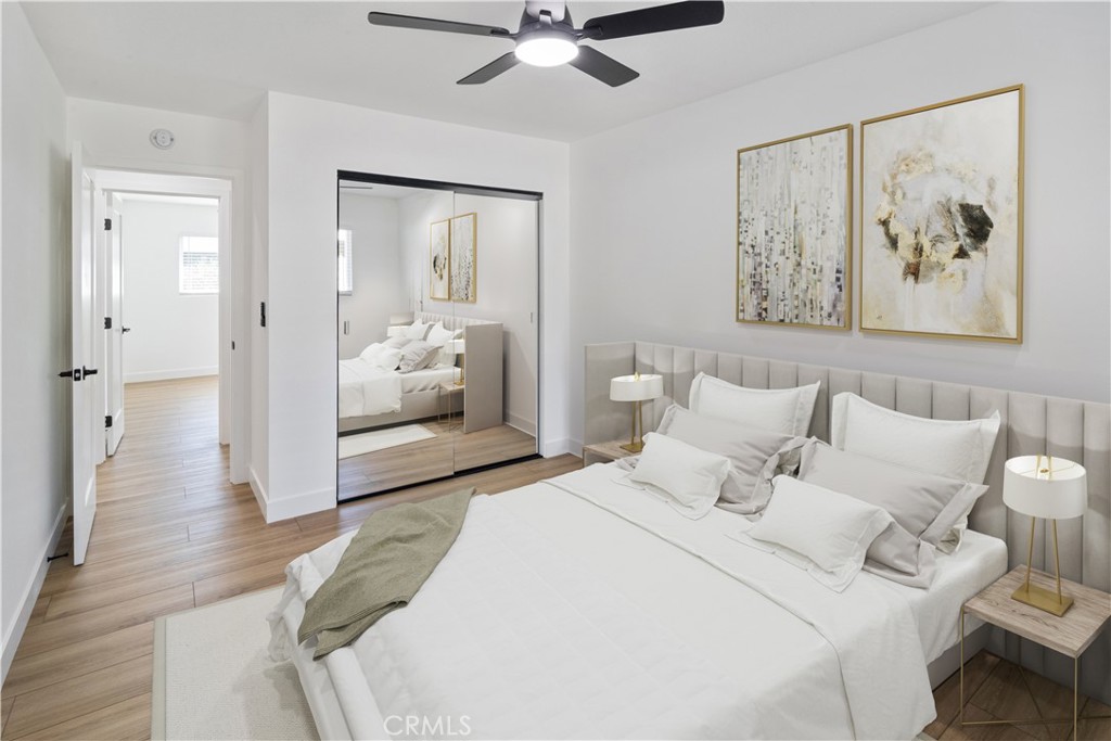 11452 Earlham Street Orange, CA 92869 - Photo 10 of 30 a bedroom with a bed and a chandelier