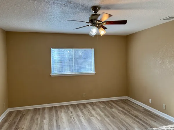 a view of room with a ceiling fan