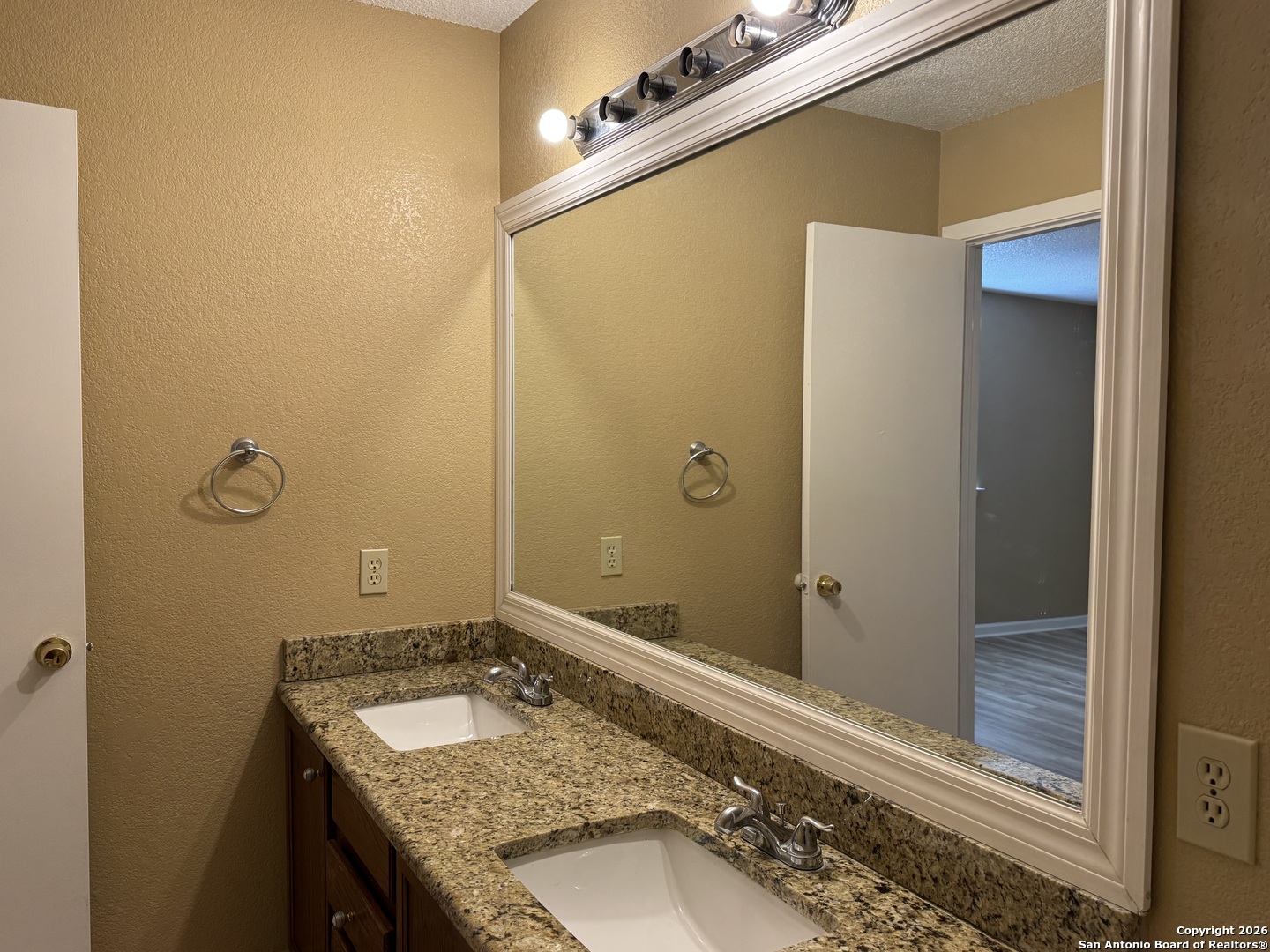 7315 Northallerton Converse, TX 78109 - Photo 12 of 22 a bathroom with a granite countertop sink and mirror