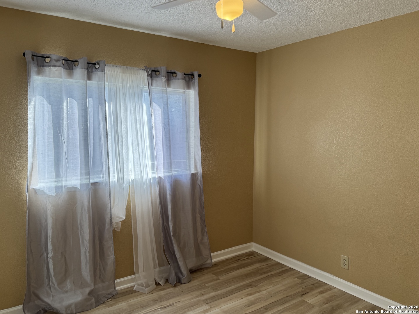 7315 Northallerton Converse, TX 78109 - Photo 15 of 22 an empty room with wooden floor and a window